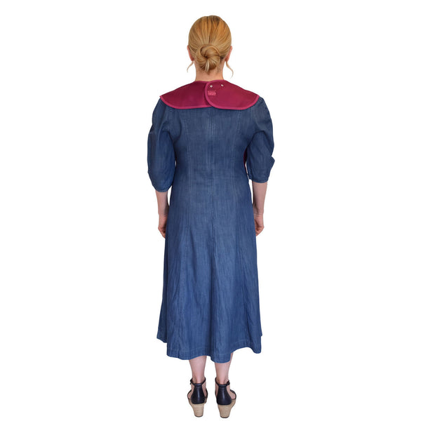 Woman wearing a Care Designs Tabard Style Adult Bib, back view.