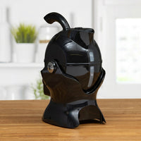 Uccello Kettle by Uccello Designs with ergonomic handle on a wooden kitchen counter, side view.