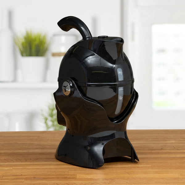 Uccello Kettle by Uccello Designs with ergonomic handle on a wooden kitchen counter, side view.