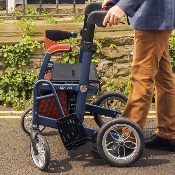 Uplivin Glide 2-in-1 rollator and wheelchair with fold-down footrests being pushed along a pavement, side view.