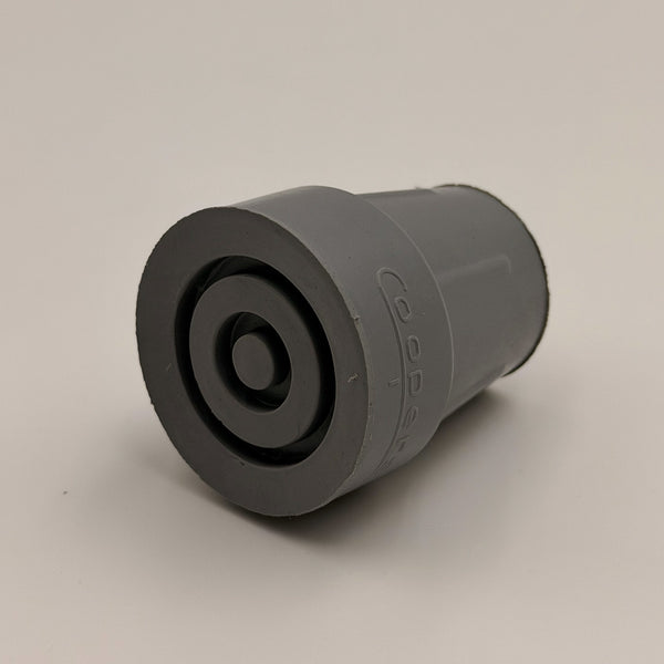Coopers walking stick ferrule, heavy-duty plastic with concentric circles and reinforced tip, plain background, close-up view.